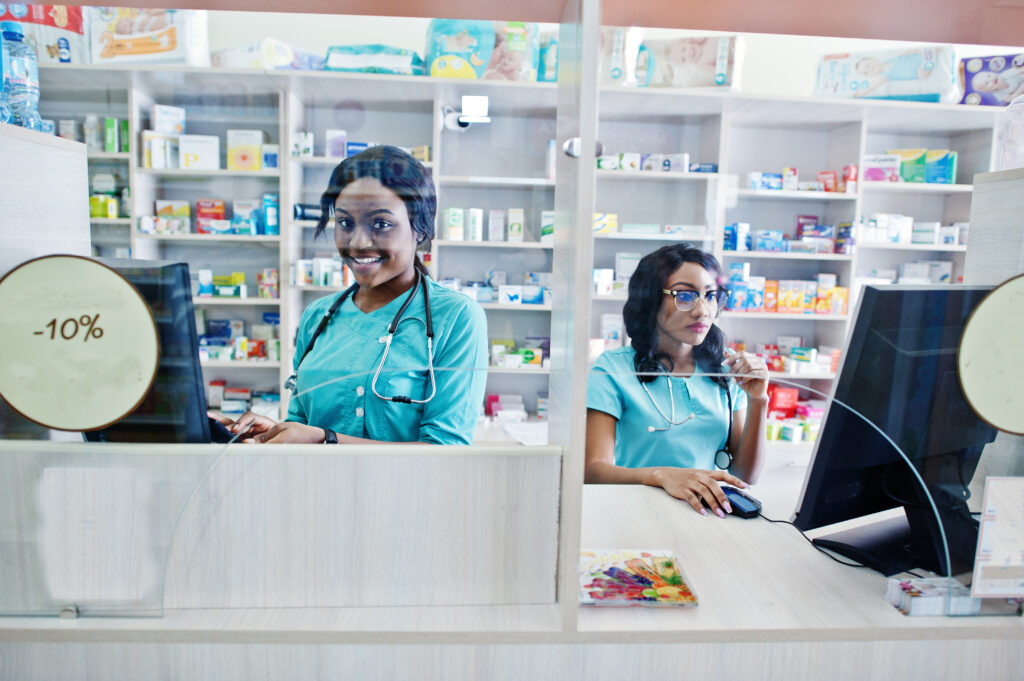 two african american pharmacist working in drugstore at hospital